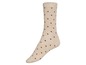 Beige Socke mit roten Punkten.