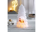 Eine weiße Weihnachtsbaumkerze mit integriertem LED-Licht und einem kleinen Weihnachtsmann.