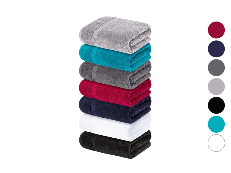 Ein Stapel Handtücher in verschiedenen Farben, darunter Grau, Türkis, Rot und Schwarz.