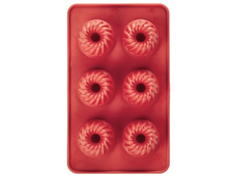 Eine rote Silikonform für sechs kleine Kuchen.