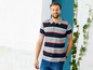 Mann trägt ein gestreiftes Poloshirt und blaue Jeans.