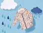 Eine Regenjacke mit Blumenmuster für Kinder, die an einem Kleiderbügel hängt.