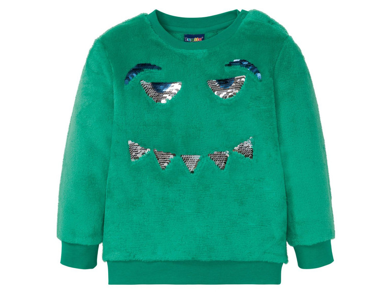 Grüner Wollpullover mit glitzernden Augen.