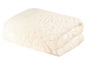Eine cremefarbene, weiche Kuscheldecke aus Kunstfell.