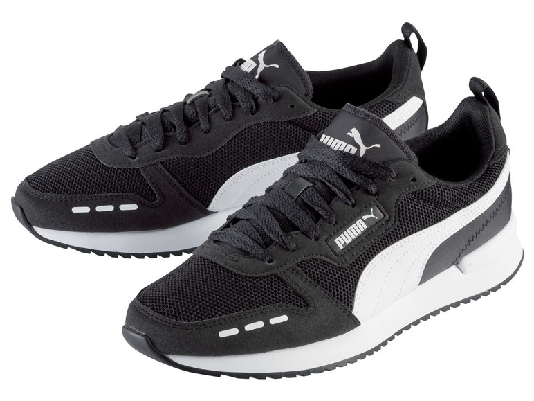 Schwarze Puma Sneaker mit Mesh- und Wildlederdetails.
