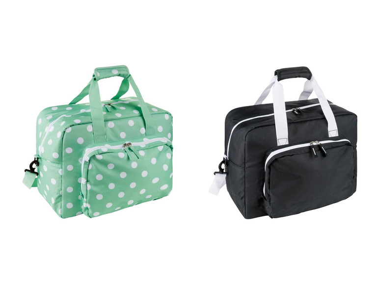 Zwei Reisetaschen, eine mit weißen Punkten auf grünem Hintergrund und eine schwarze.