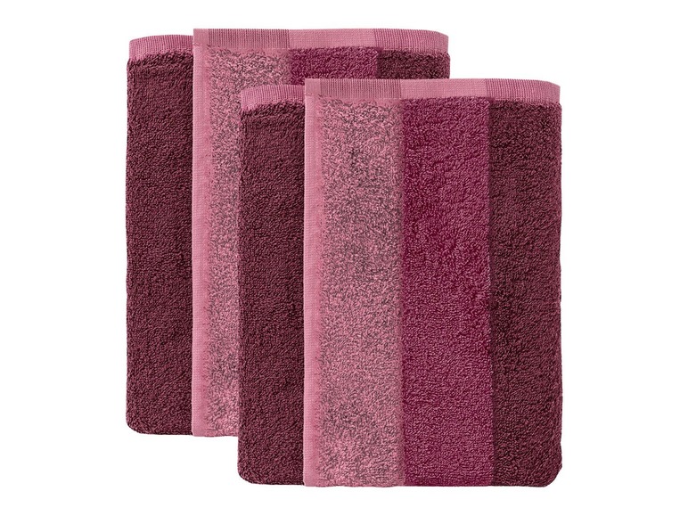 Drei Handtücher in Rosa- und Lilatönen.