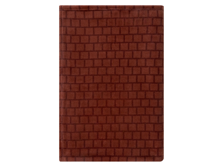 Eine braune Badezimmermatte mit einem Ziegelmuster.