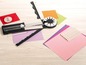 Eine Schneidematte, ein Locher und buntes Papier zum Basteln.