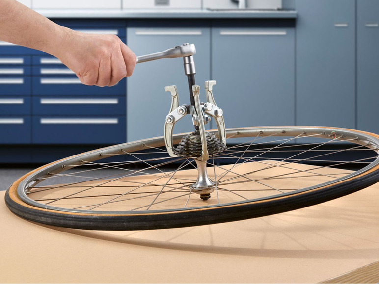 Ein Rad mit Kassette wird mit einem Werkzeug befestigt.