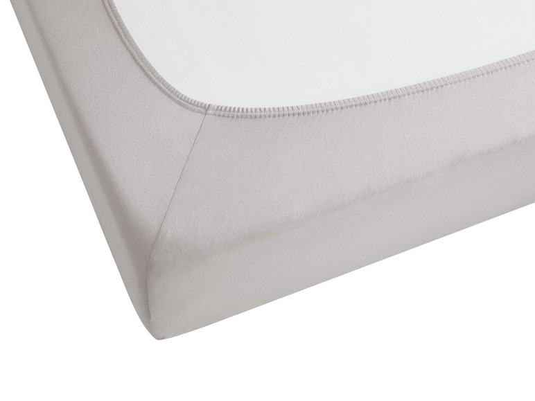 Ein graues Spannbettlaken mit Gummizug.
