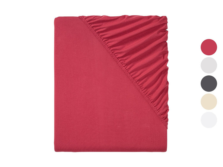 Ein rosafarbenes Spannbettlaken.