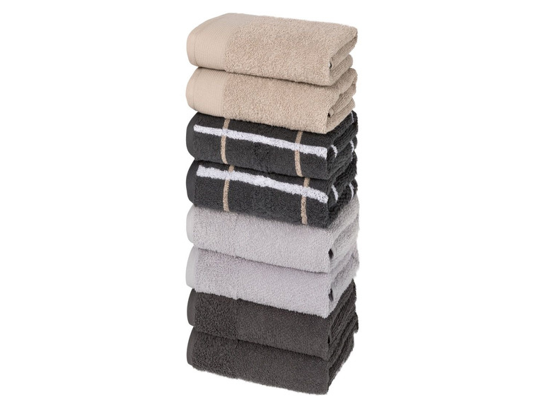 Stapel Handtücher in Beige, Grau und Schwarz mit weißen Streifen.