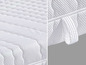 Eine weiße Matratze mit gestepptem Stoff und einem Griff.