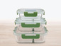 Drei gläserne Lunchboxen mit grünen Deckeln.