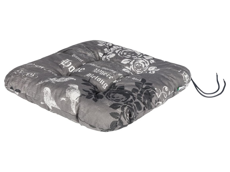 Ein grauer Stuhlbezug mit Blumen- und Vogelmotiv, mit dem Schriftzug 'Home'