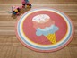 Runder Teppich mit Eiscreme-Motiv, daneben zwei rosa Rollschuhe