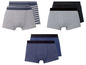 Drei Paar Boxershorts, grau, blau und gestreift.