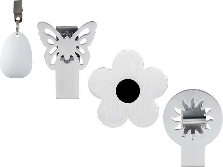 Ein Set mit vier Tischklemmen in Form von Schmetterling, Blume, Sonne und Ei.