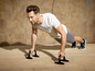 Mann macht Liegestütze mit Push-up-Griffen.