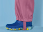 Blaue Gummistiefel mit rosafarbenen Hosenbeinen.