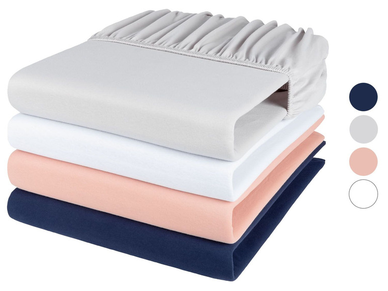 Stapel mit Bettwäsche in Grau, Weiß, Rosa und Dunkelblau.