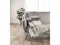 Eine graue und weiße Plaid auf einer grauen Couch.