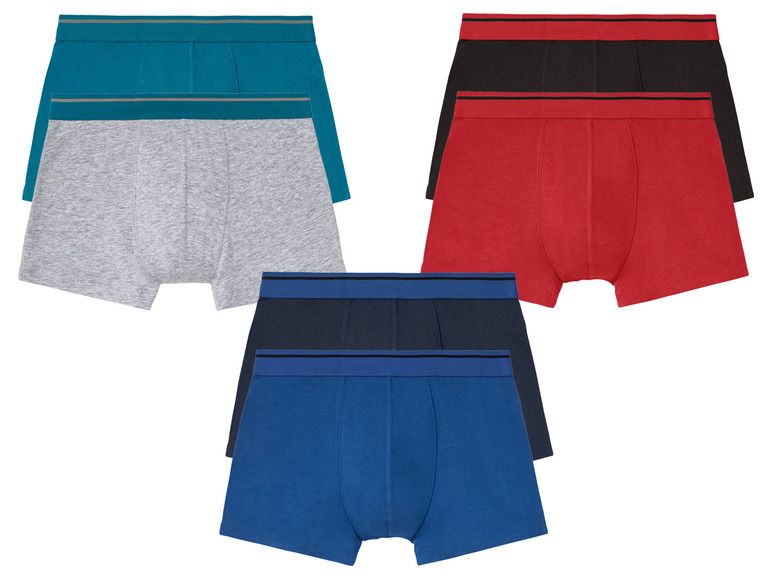 Drei Paar Boxershorts in verschiedenen Farben.