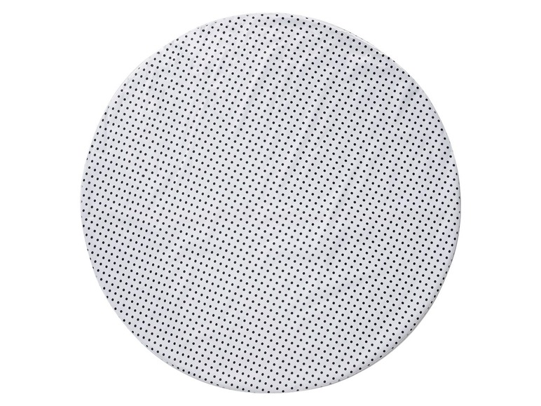 Ein runder Untersetzer mit schwarzen Punkten.