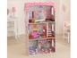 Ein rosa Holzpuppenhaus mit einer Wendeltreppe, Möbeln und einer Küche.