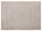 Beige Badezimmermatte mit einem detaillierten Randdesign.