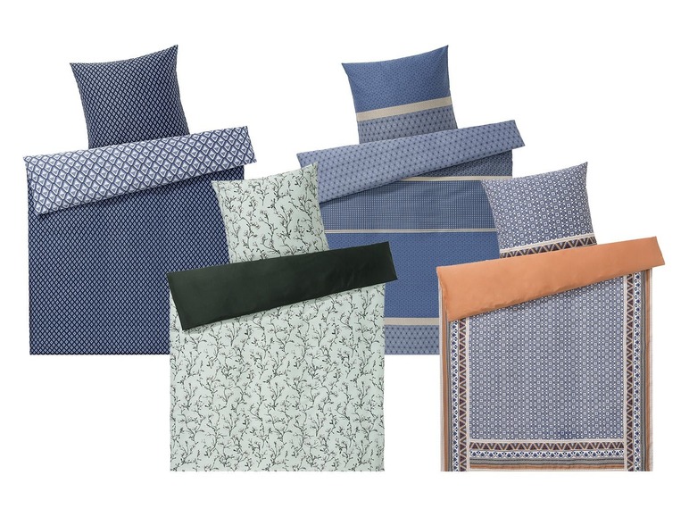 Bettwäsche mit verschiedenen Mustern, darunter eins mit Zweigen.