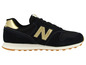 Schwarze New Balance Sneaker mit goldenen Akzenten.