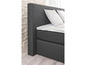 Ein graues Boxspringbett mit Matratze und Kopfteil.