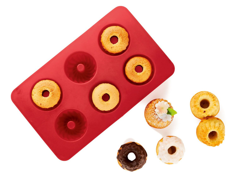 Eine rote Silikonform mit gebackenen Kuchen.