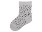 Eine graue Socke mit schwarzen Punkten.