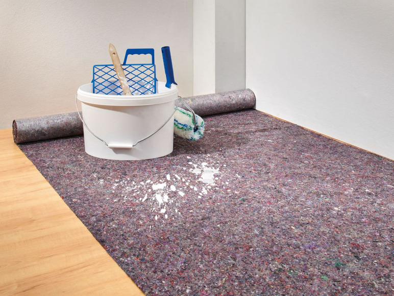 Ein Farbeimer und eine Rolle auf einem geschützten Boden.