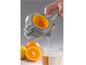 Eine Zitruspresse mit Orangen und einem Glas Saft.