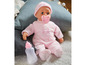 Eine rosa Baby-Puppe mit Schnuller und Flasche.