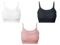 Drei Paar nahtlose Sport-BHs in Weiß, Schwarz und Rosa.