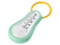 Ein grüner Babybjörn Badethermometer mit einem gelben Ring.