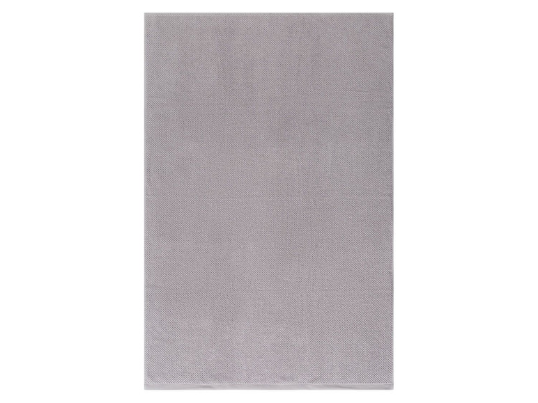 Eine graue Badezimmermatte mit Textur.