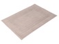 Beige Badezimmermatte mit gesticktem Rand.