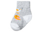 Graue Babysocken mit gelben Vögeln.
