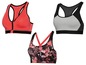 Drei Sport-BHs: ein rosa mit Reißverschluss, ein grauer mit Schwarz und ein floral gemusterter.