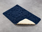 Eine dunkelblaue Badematte mit Muschel-Textur.
