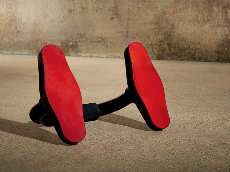 Eine schwarze Push-up-Stange mit roten Griffen.