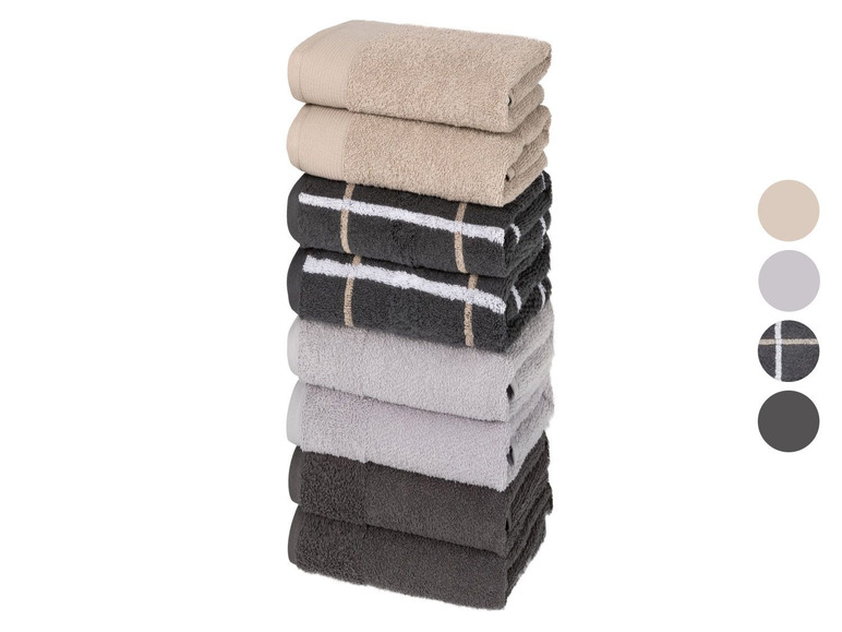 Ein Stapel Handtücher in Beige, Grau und Schwarz mit Karomuster.