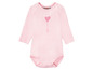 Ein rosa Baby-Body mit einem Herzballon-Motiv.