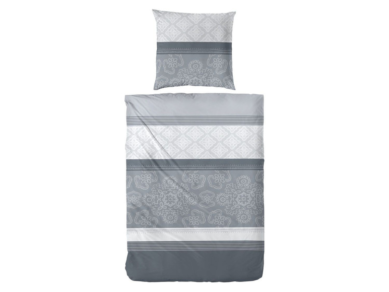 Ein grauer Bettbezug mit weißem Damast- und Blumenmuster.